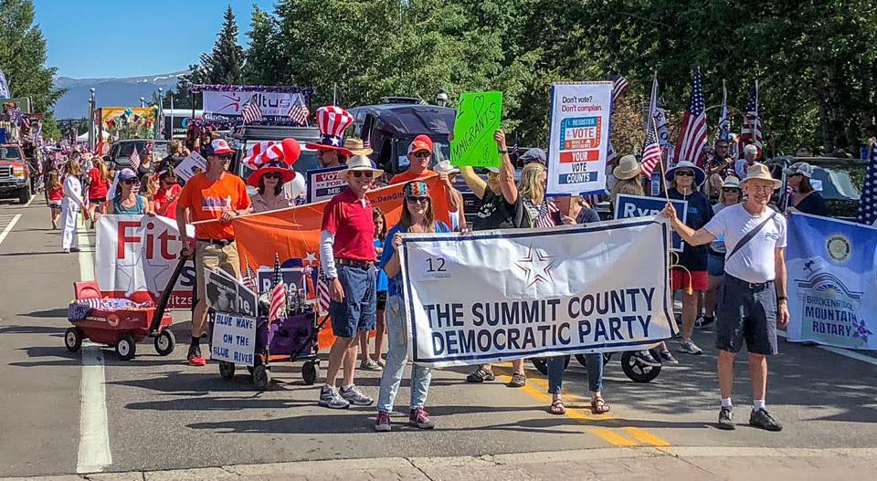 Treasurer Ryne Scholl and Commissioner Elisabeth Lawrence march in the Summit Democrats July 4th Parade